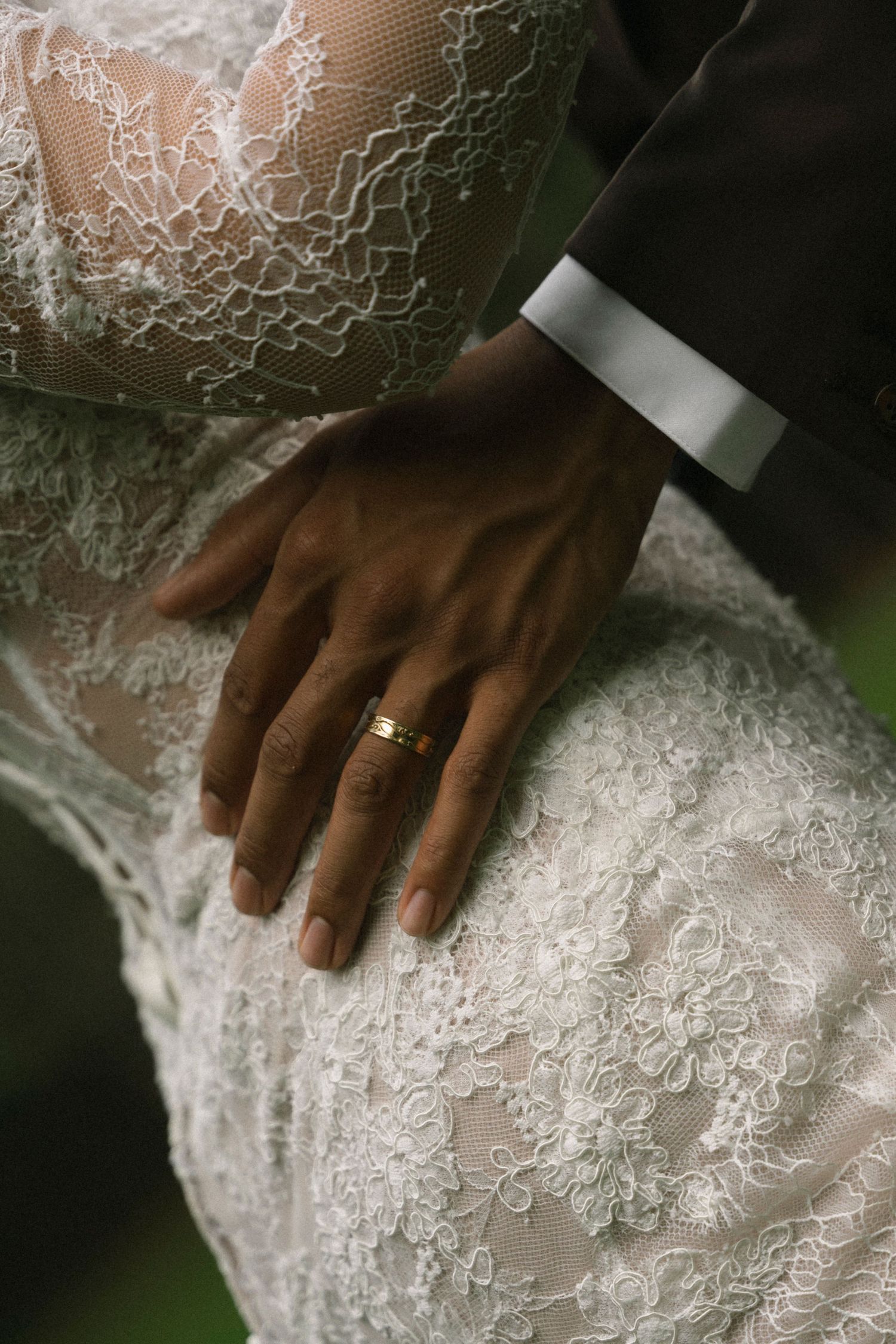Close-up shots of delicate white lace wedding dress details with a diamond ring visible.