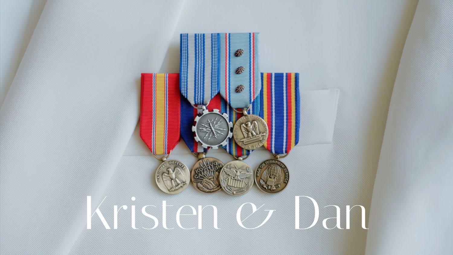 Military medals and decorations displayed in a row on a white surface.