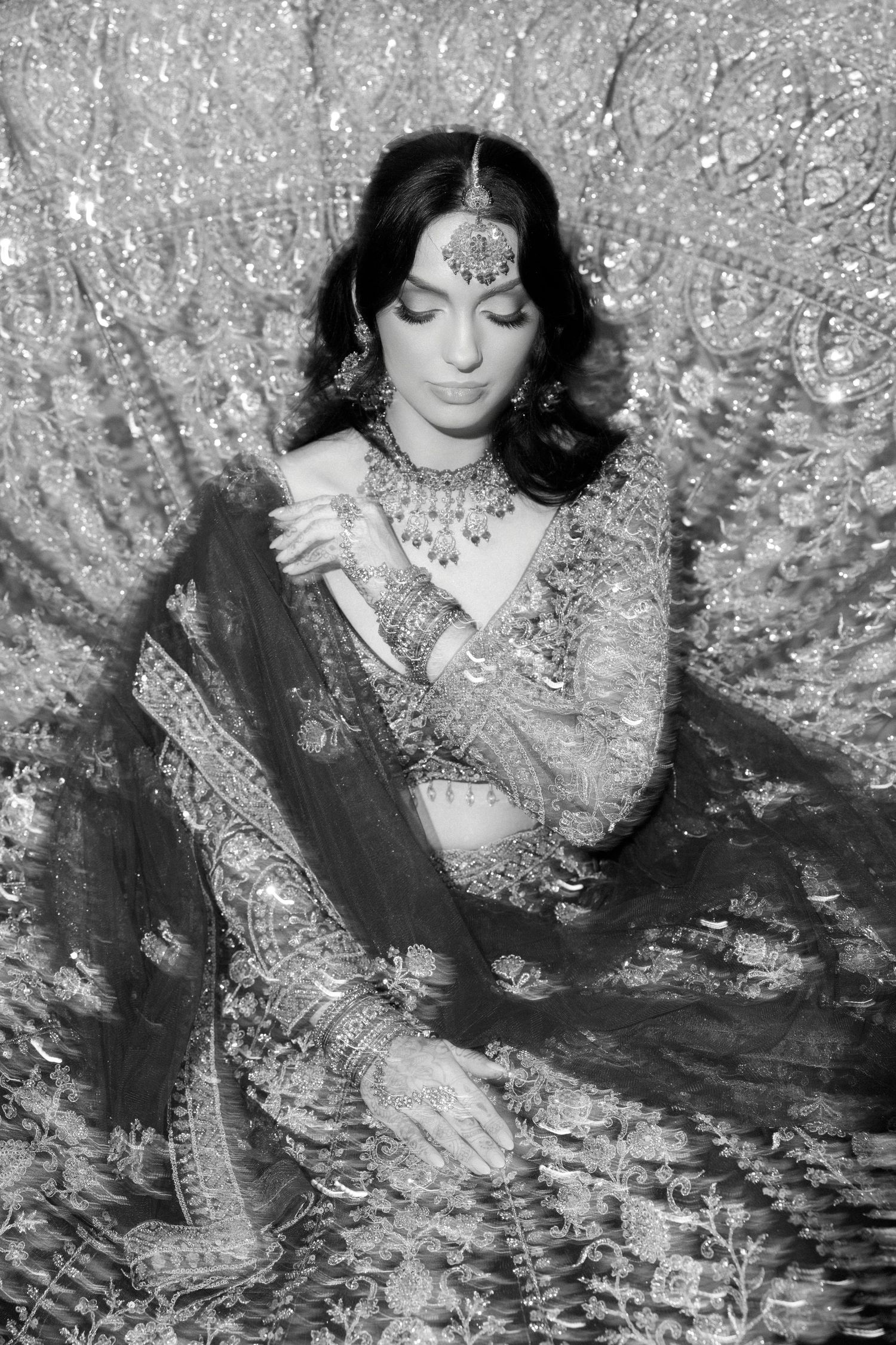 Black and white artistic portrait with overlapping reflective patterns creating a dreamy effect.