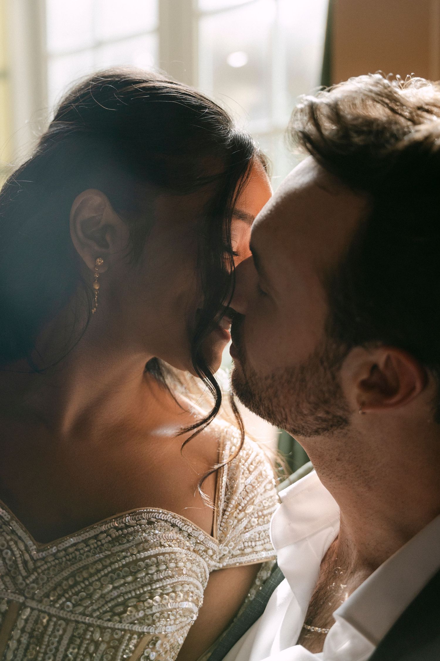 A romantic series of close-up shots showing a tender kiss in warm sunlight with soft bokeh effects.