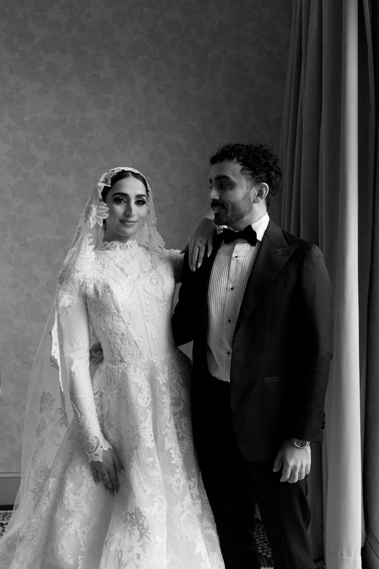 A series of black and white wedding photos showing a couple in traditional bridal attire with a lace gown and tuxedo.