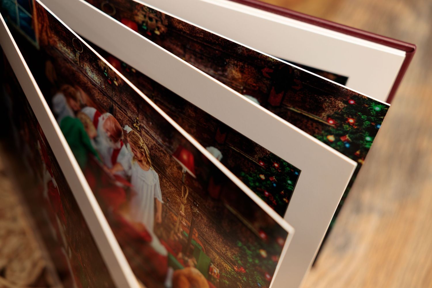 A series of framed photographs arranged in a diagonal line on a wooden surface.