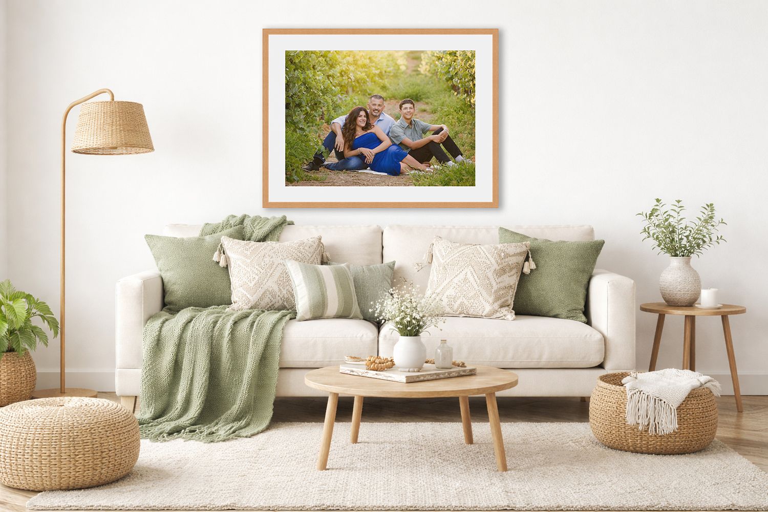 Modern living room interior with sage green accents, white walls, natural wood furniture and woven pouf ottoman.