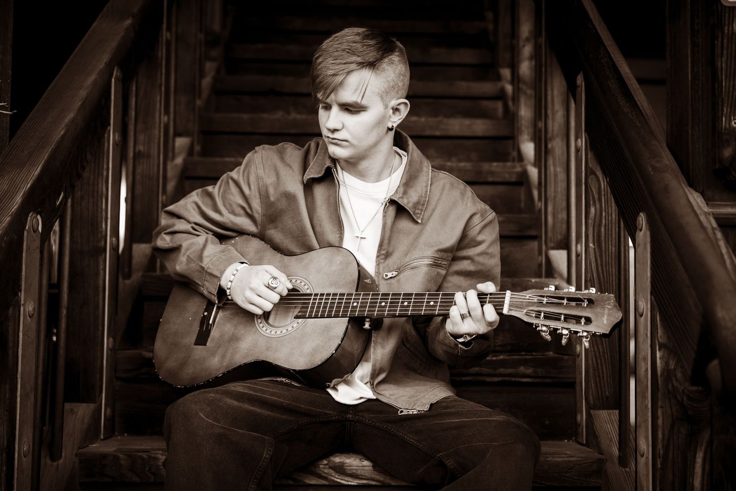 A series of black and white portraits showing a person playing guitar and posing in different artistic angles.