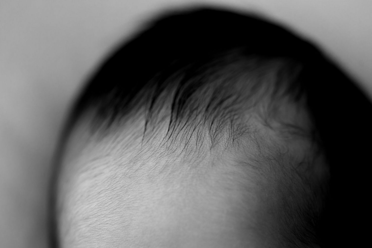 A close-up view of a person's eye with long eyelashes and natural makeup.