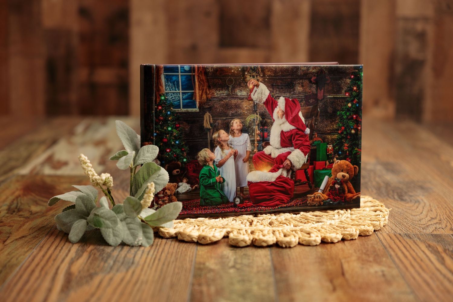 A festive Christmas scene with Santa Claus decorations, cookies, and poinsettia flowers arranged on wooden surfaces.