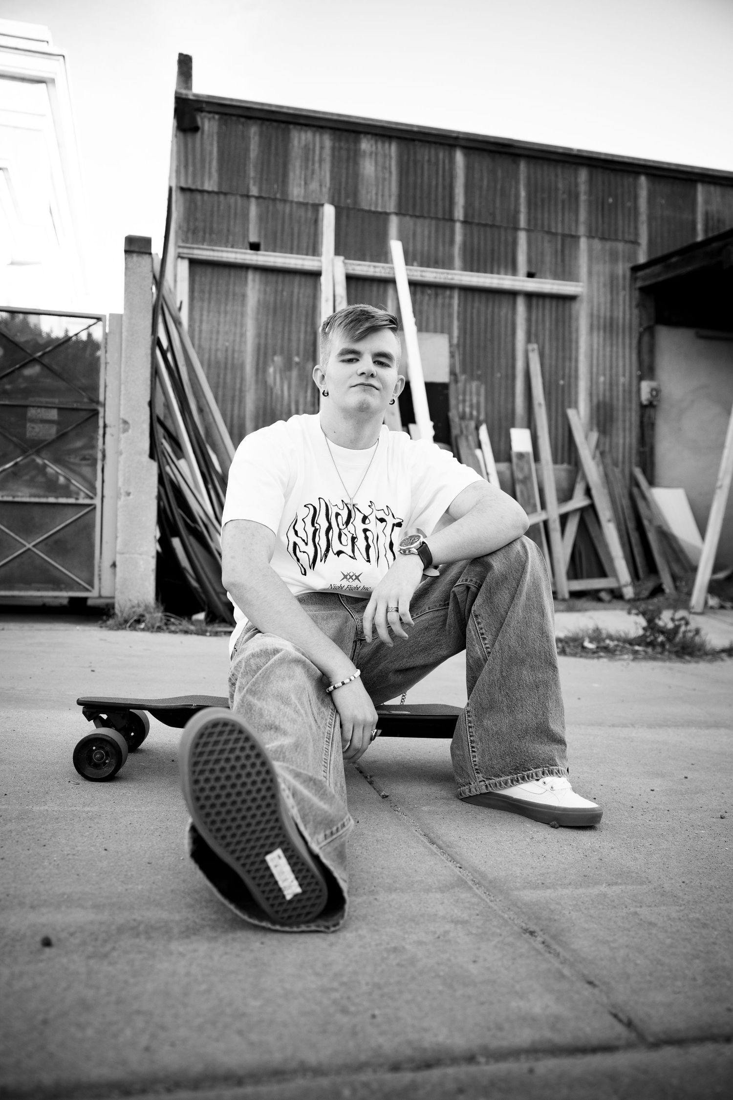 Black and white photo sequence showing someone sitting on concrete ground in urban setting.
