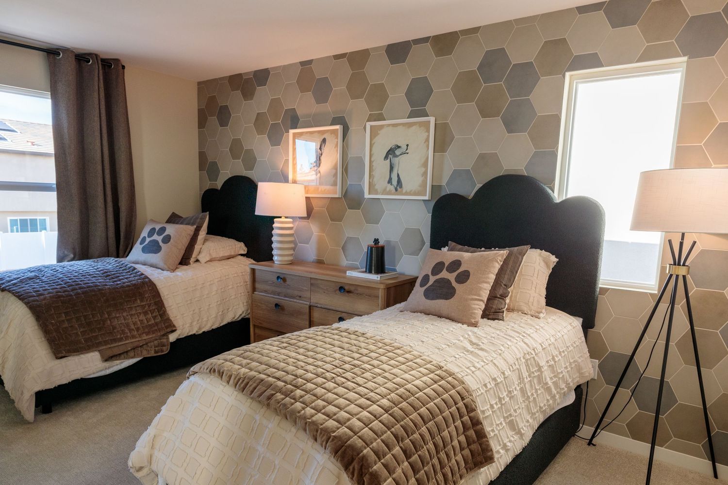 Modern bedroom with hexagonal wall decor, neutral tones, and contemporary furnishings creates a stylish sleeping space.