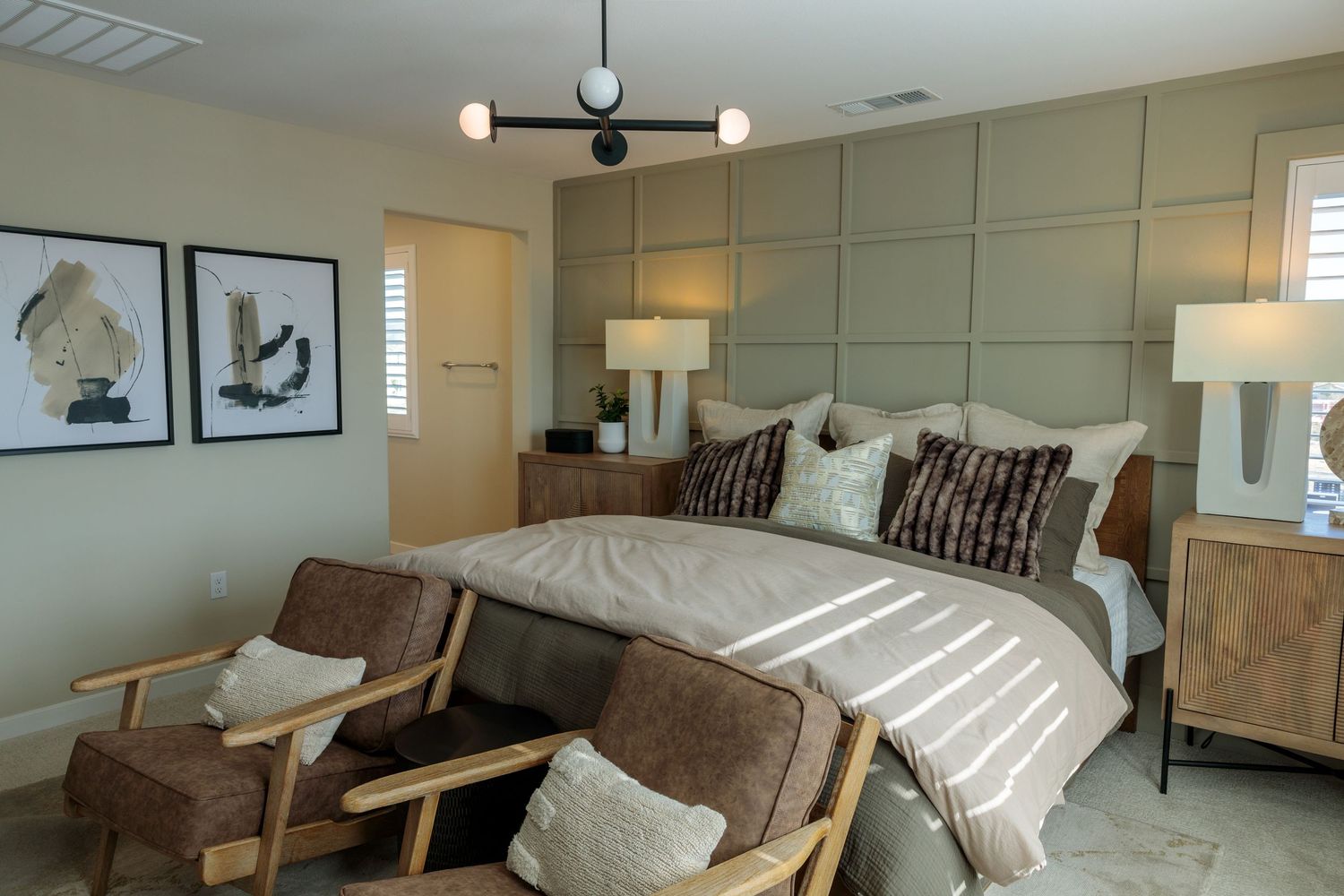 Modern bedroom interior with brown furniture, white bedding, and recessed lighting creates a cozy atmosphere.
