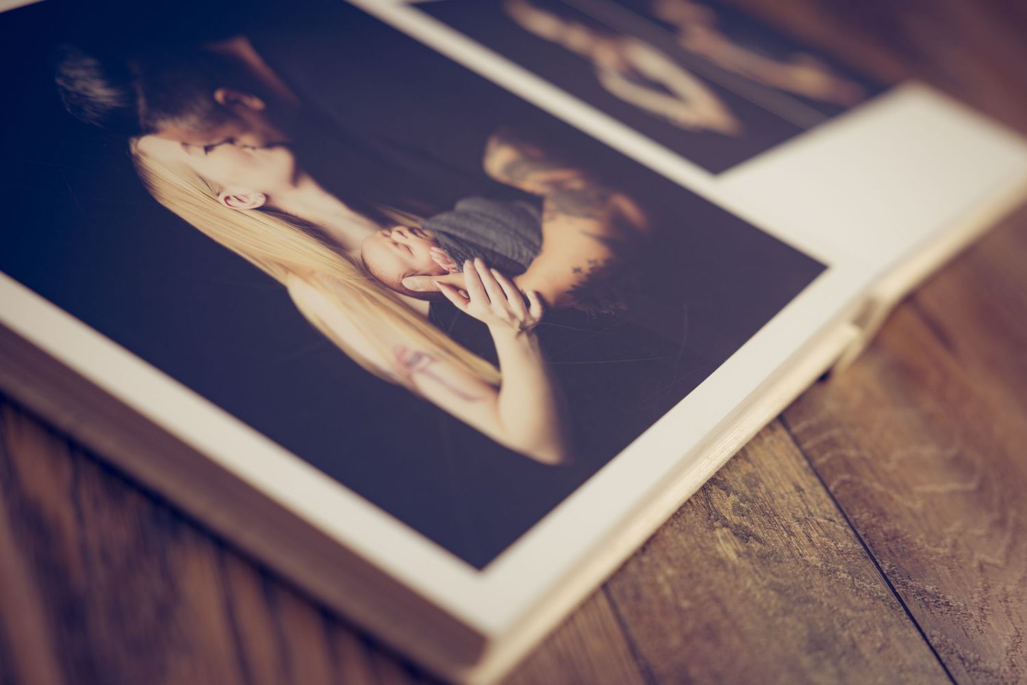 A series of vintage-style photographs laid out in a row on a wooden surface.