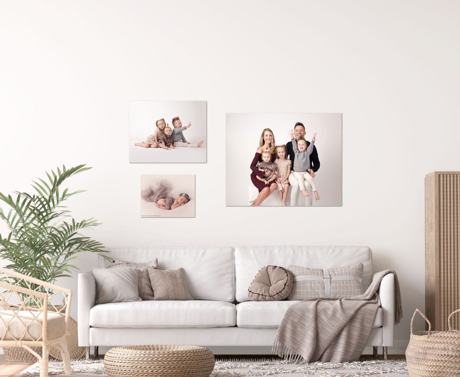 Modern living room interior with family photos displayed on white wall above gray sofa.