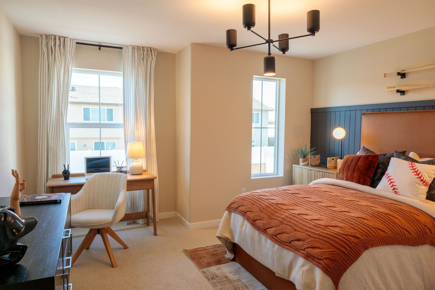 A series of bedroom views showcasing a contemporary space with warm lighting and rust-colored bedding.