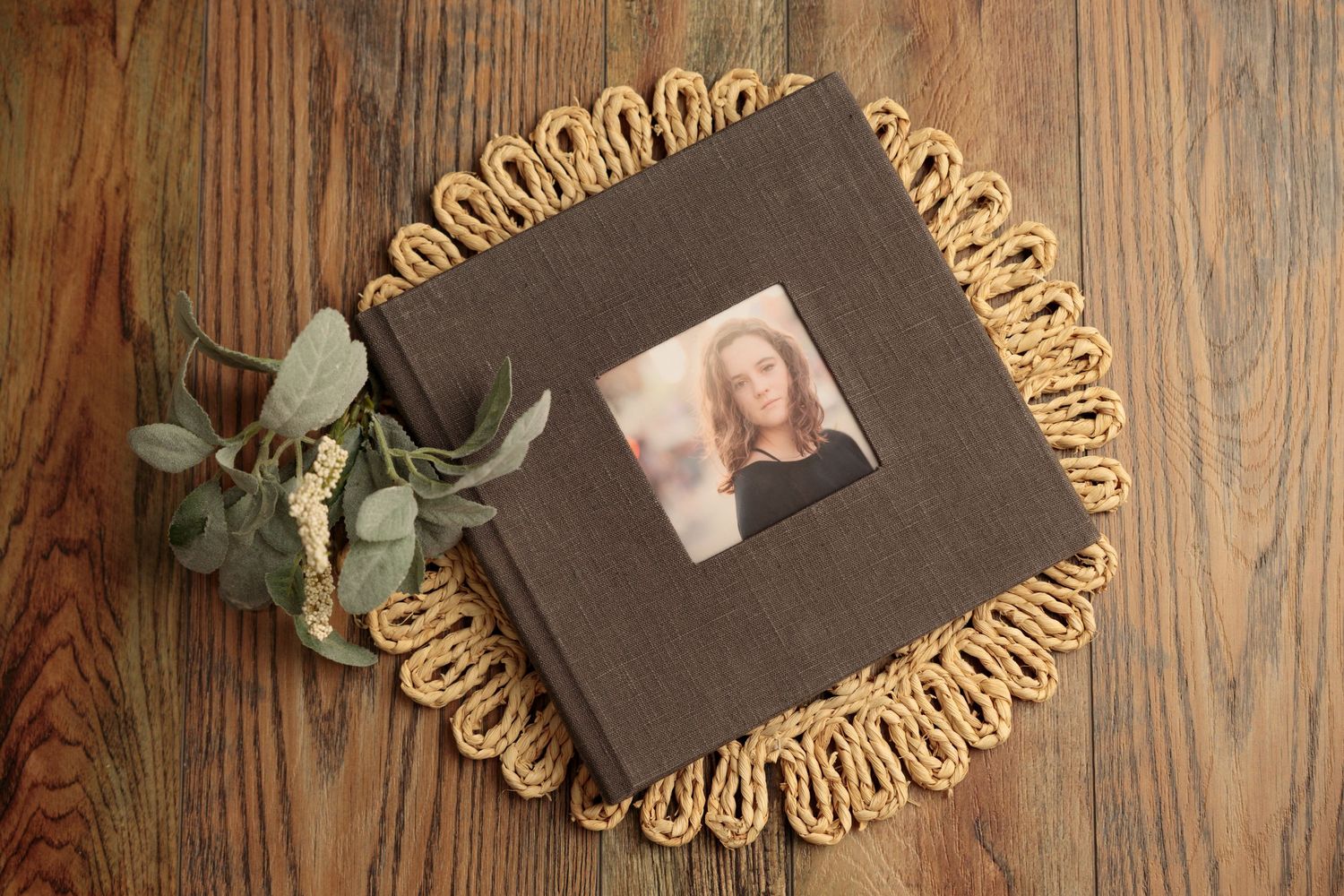 Handmade macrame wall hangings and plant holders displayed on a rustic wooden background with greenery accents.