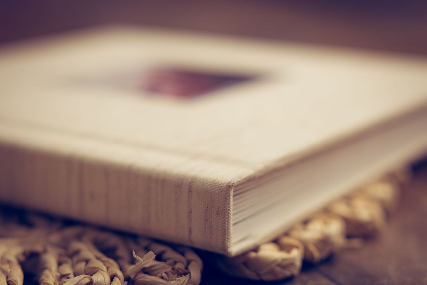 A close-up view of an open book with blurred pages creating a dreamy depth of field effect.