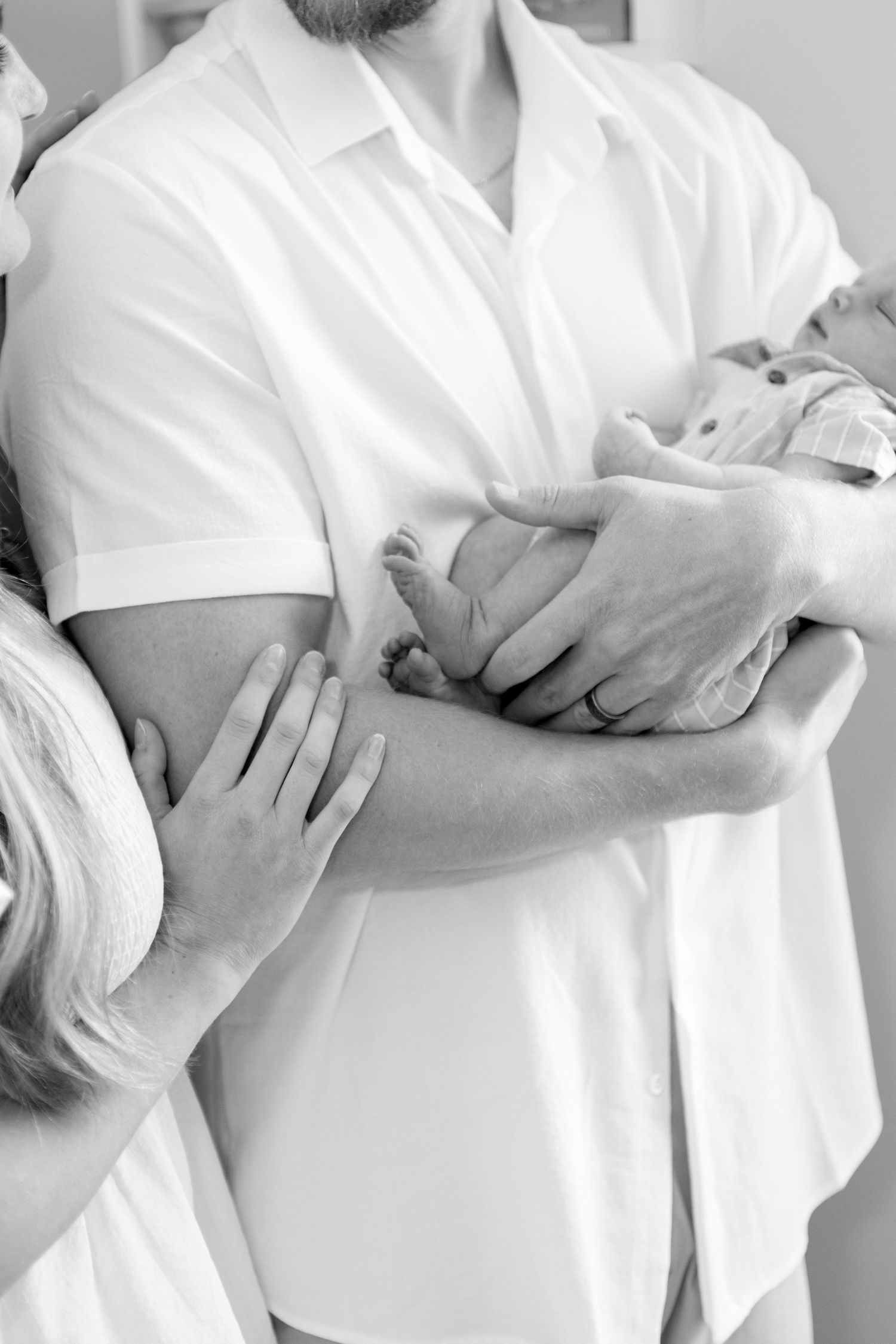 A series of monochrome photos showing a pregnant belly in white clothing at different stages of pregnancy growth.