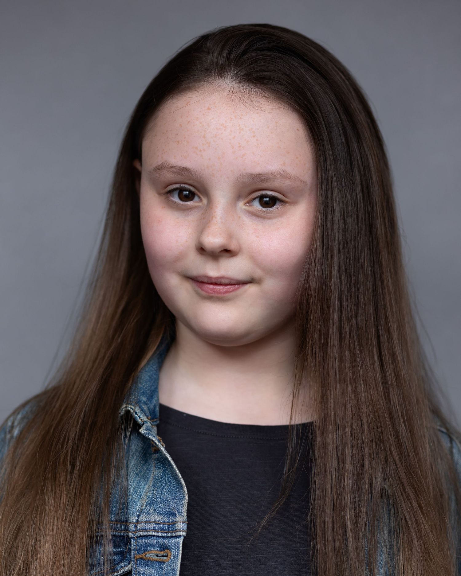 Girl with her hair down posing for an acting headshot in Manchester, displaying confidence and poise during a professional headshot session