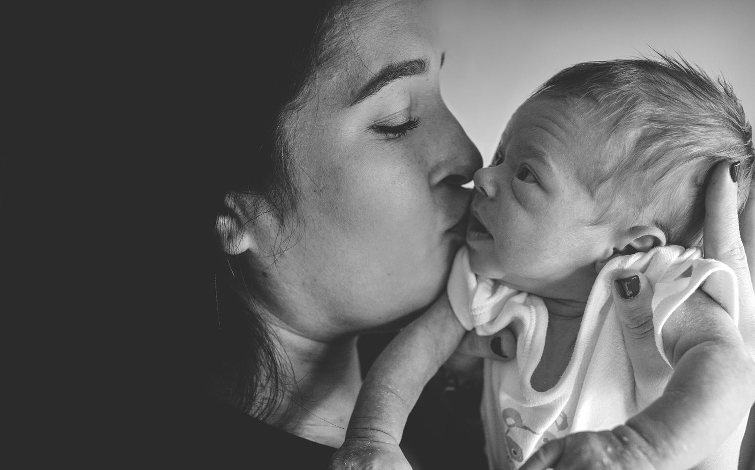 Natural newborn photography in Prestwich, capturing intimate moments between parents and baby