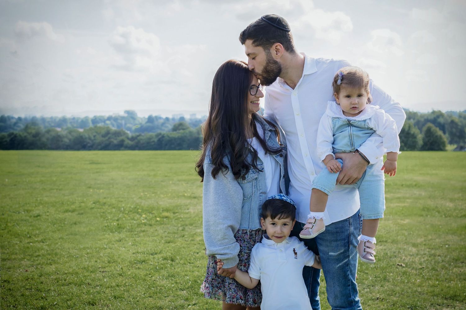 Outdoor family photo taken in a local park during spring in Prestwich, Manchester