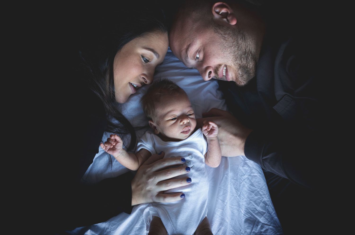 Lifestyle newborn session in Prestwich, Manchester, capturing tender moments between parents and their newborn baby.