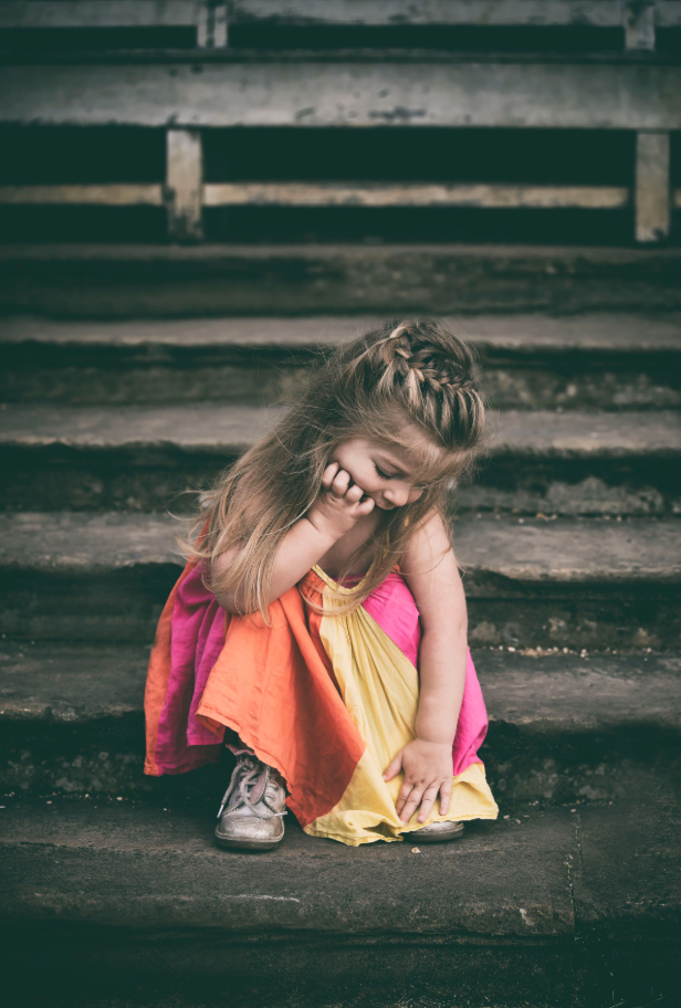 Outdoor family photography session in Manchester. Little girl sitting on steps of stately house in a local park. Whitefield.