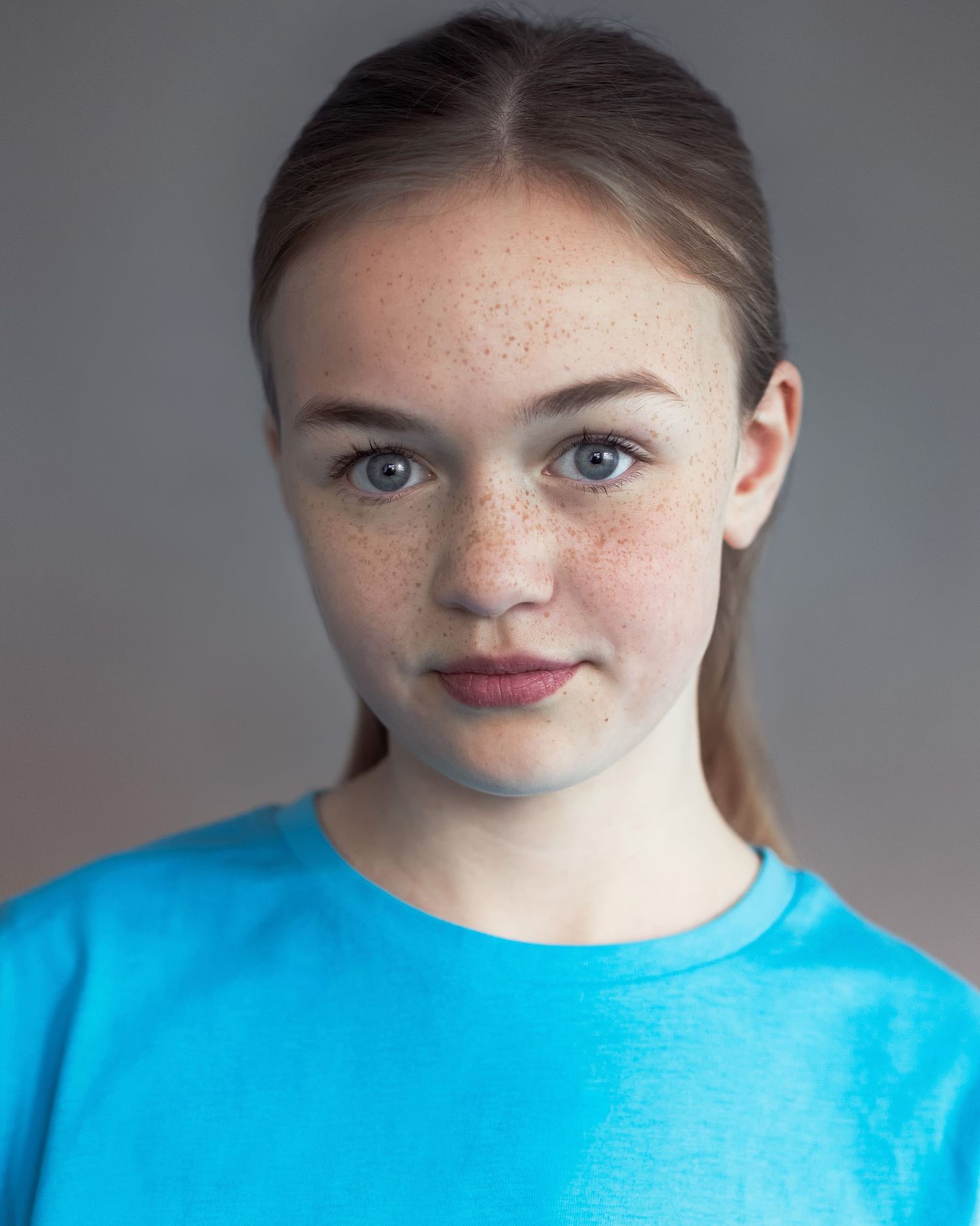 An acting headshot of a young girl in Manchester, looking confident and poised during a professional headshot session
