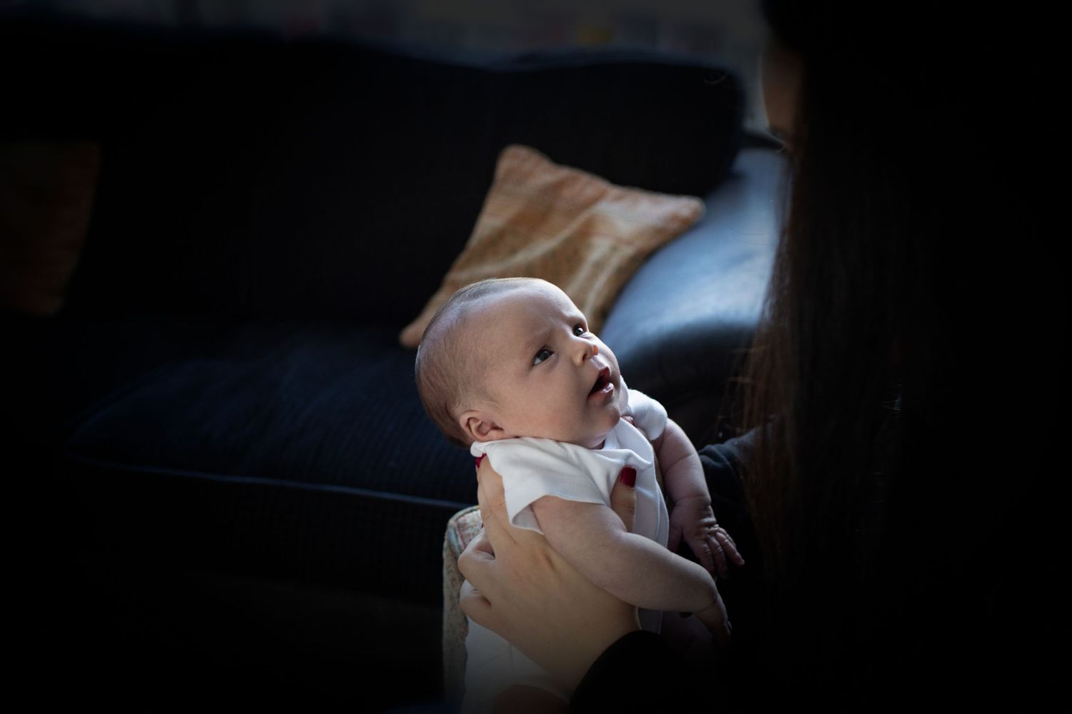 Close-up of a newborn baby’s eyes looking lovingly in an intimate family photo session in Prestwich