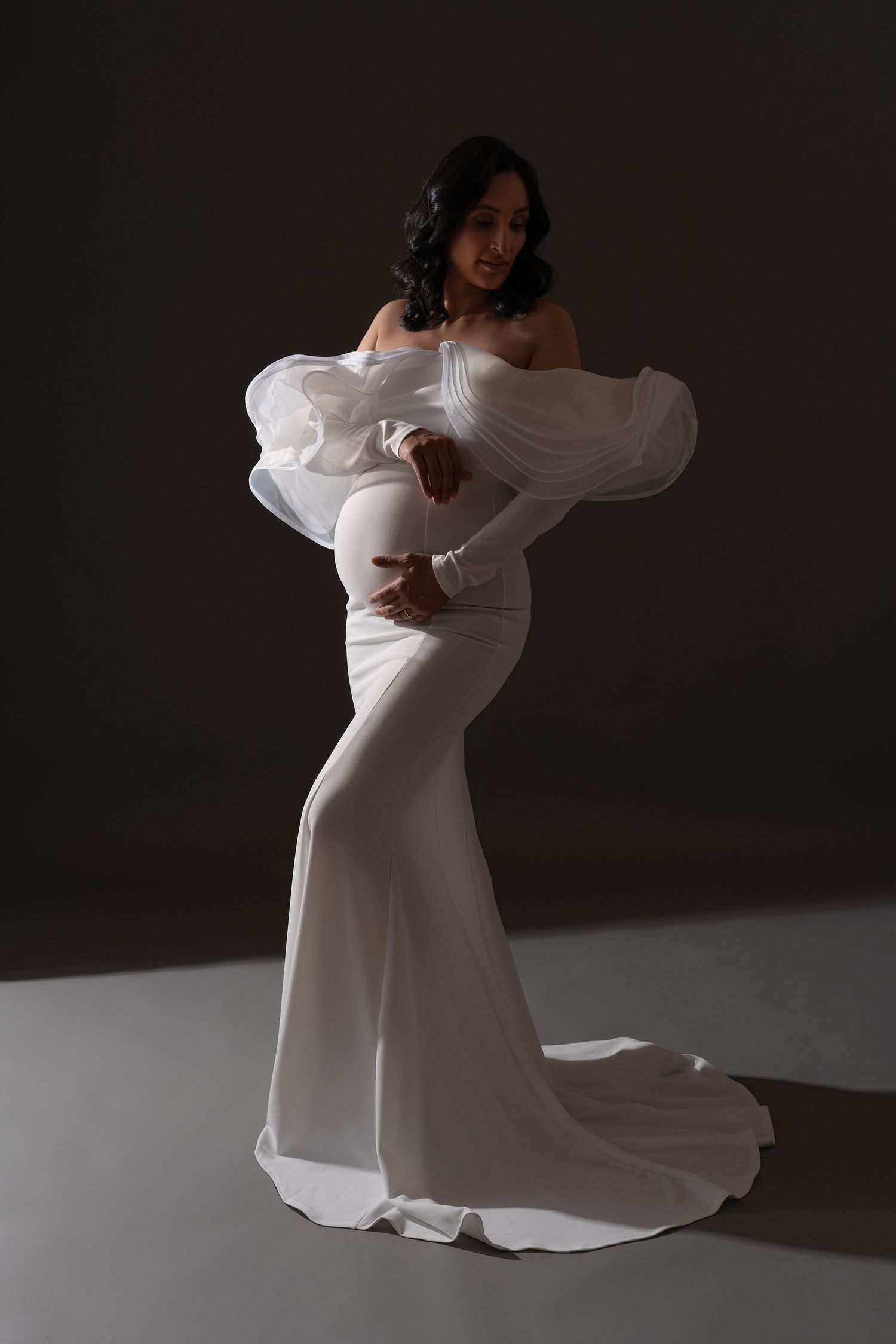 Studio maternity photoshoot in Chicago — pregnant woman in a white evening gown.