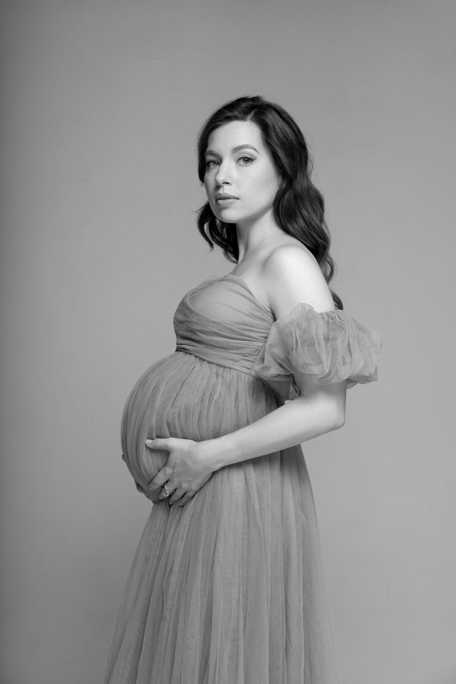 Elegant black and white maternity shot highlighting the curves and beauty of pregnancy in photo studio in Chicago.