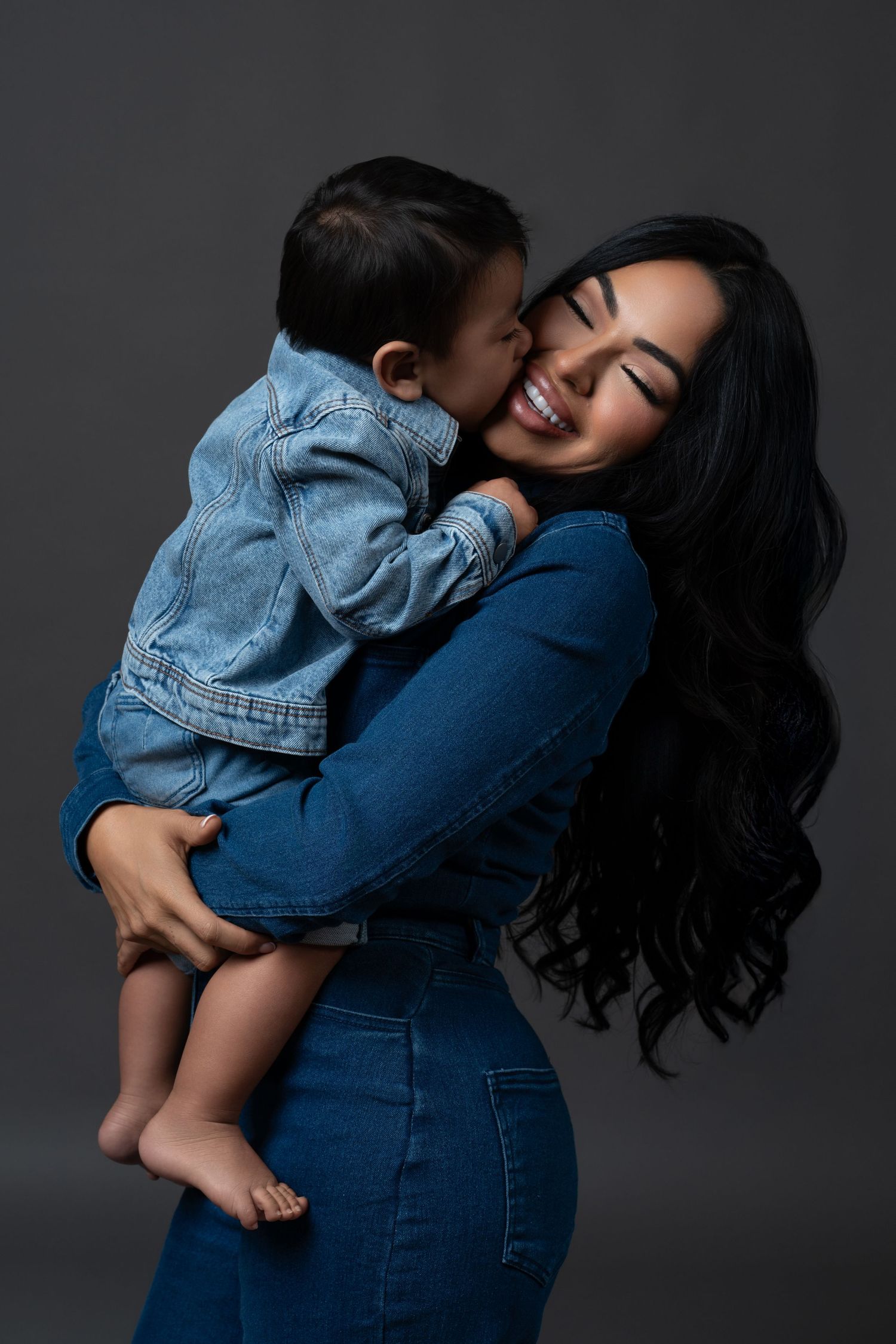 Mommy and me photo session in total denim outfits, mom with long dark curly hair. Photoshoot in Chicago.