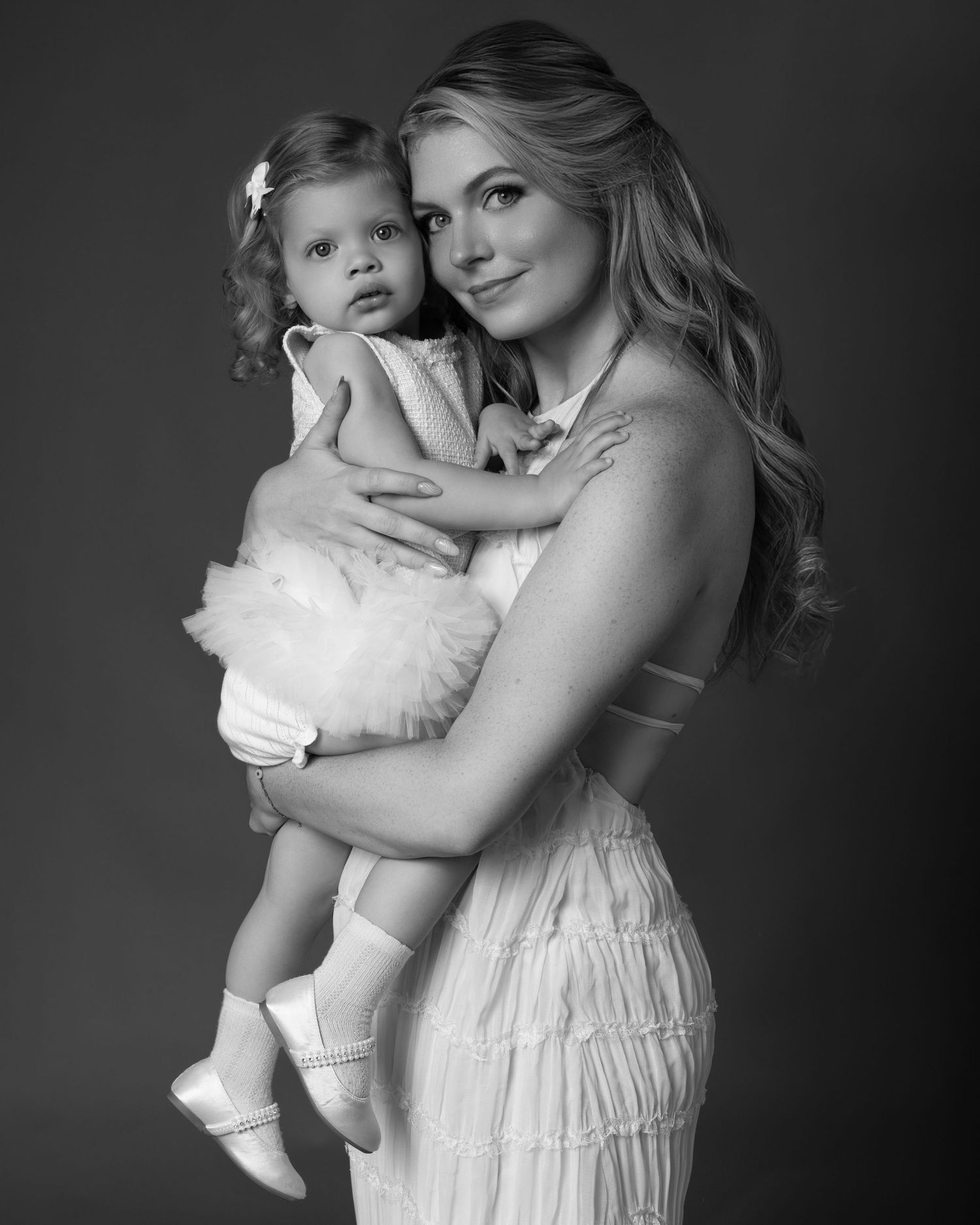 Black and white mommy and me portrait taken during a studio photoshoot in Chicago, featuring a two-year-old girl.