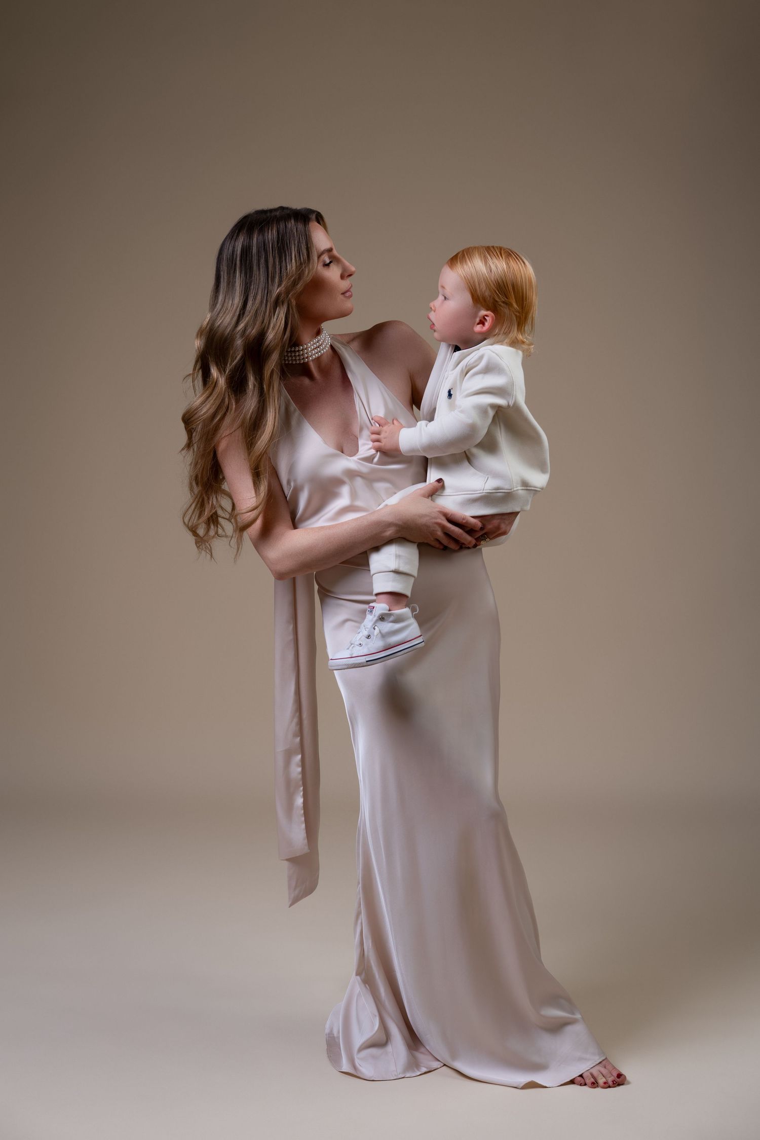 legant mommy and me maternity portrait of an expectant mother with her toddler son during a Chicago studio session.