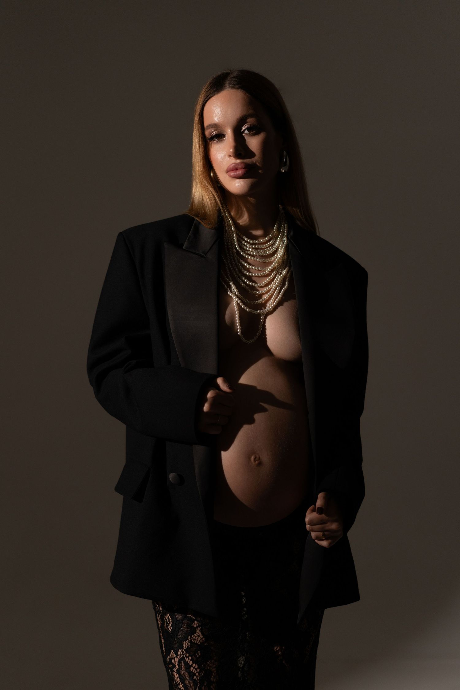 Timeless maternity photography capturing the beauty of pregnancy in a soft, minimal setting in Chicago studio.