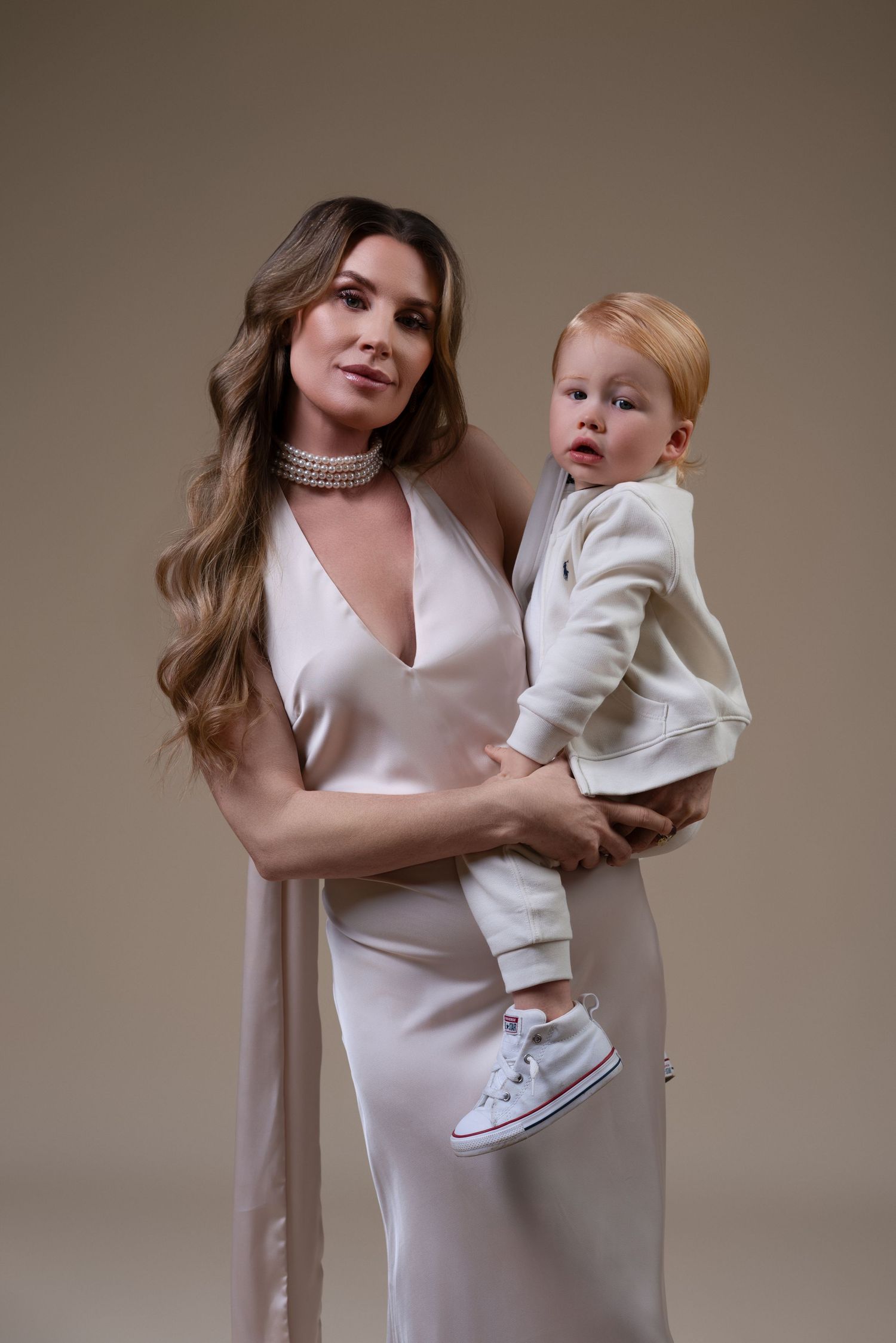 Mommy and me photoshoot in Chicago featuring a pregnant mother and her two-year-old son sharing a tender moment together.