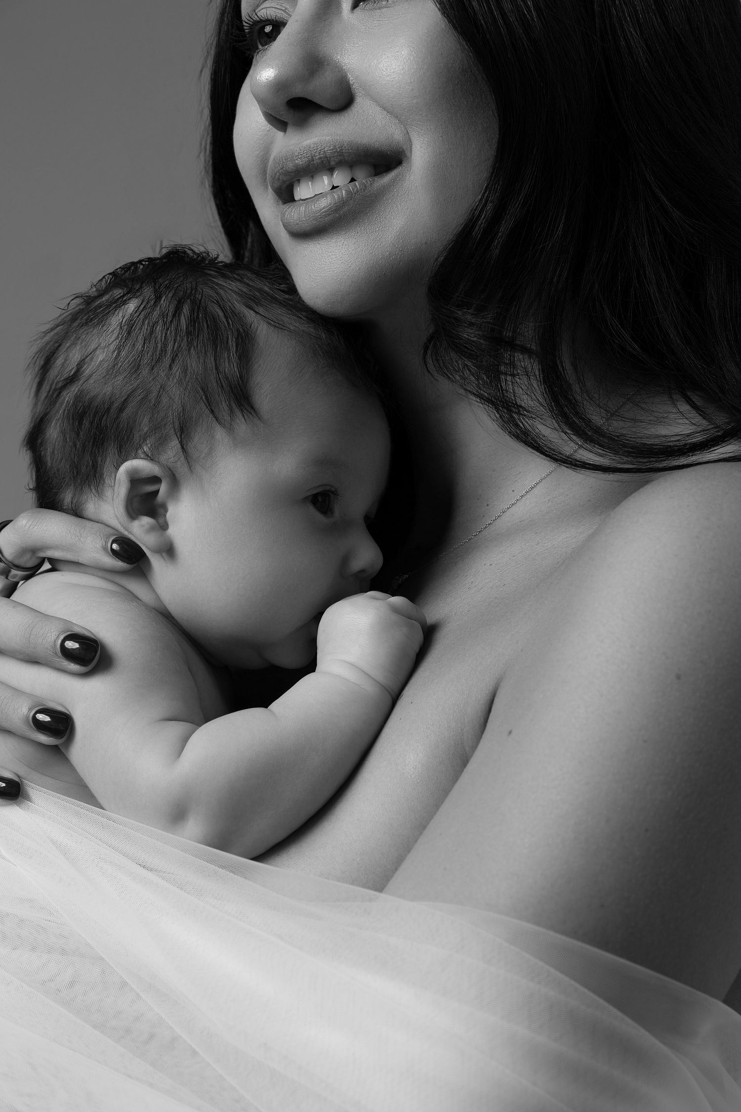 Intimate black and white Mommy and Me newborn photos in a Chicago studio, with mother and baby in a natural nude setup.