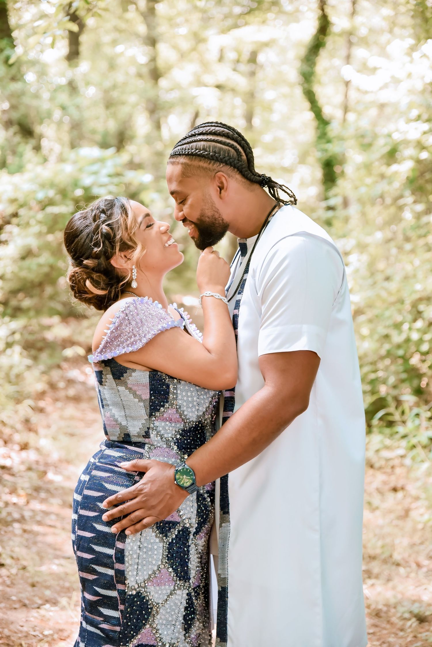 A tender family moment captured in a wooded setting showing parents embracing with their child.