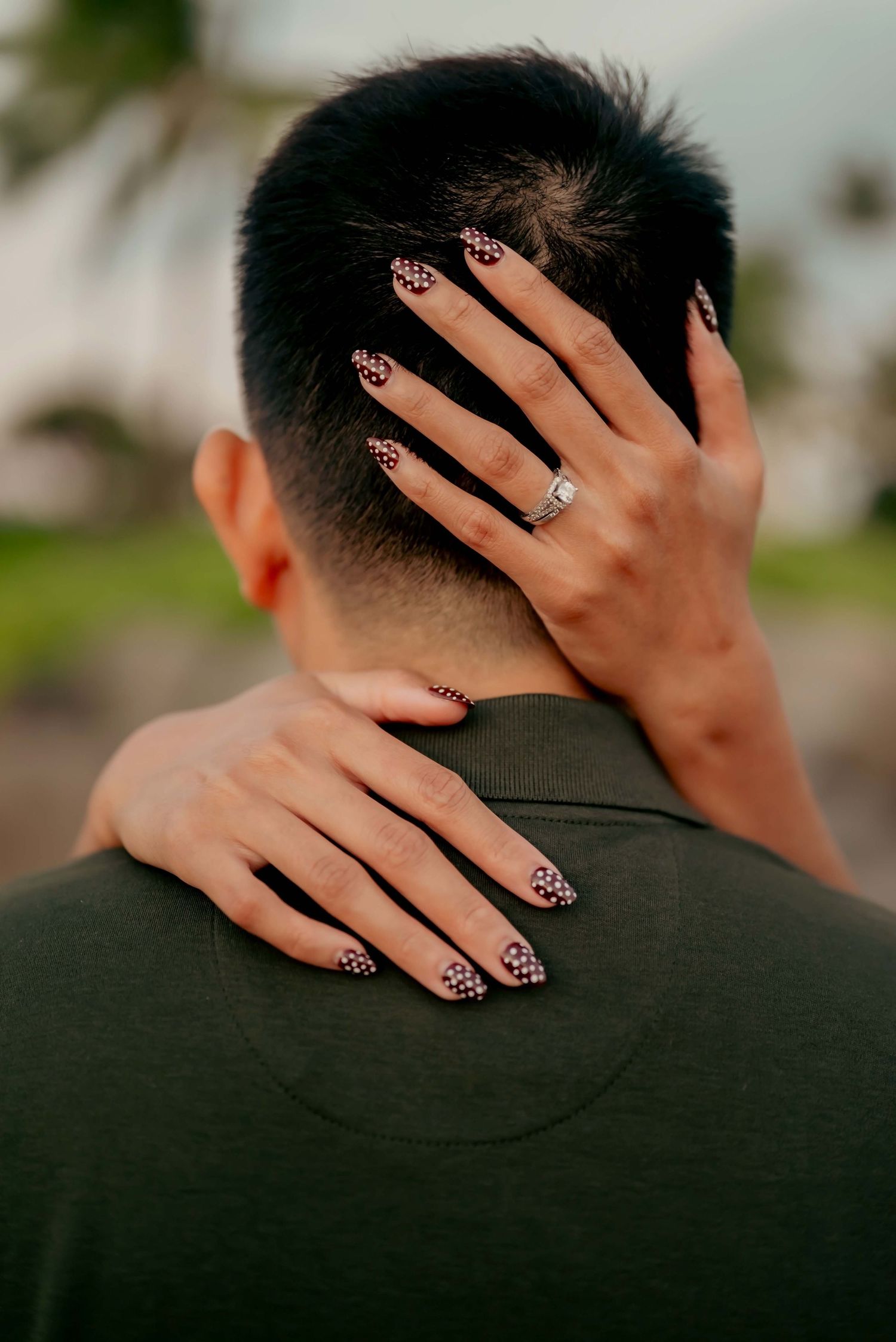 A person's hand with leopard print nails rests gently on the back of someone's neck in a series of intimate poses.