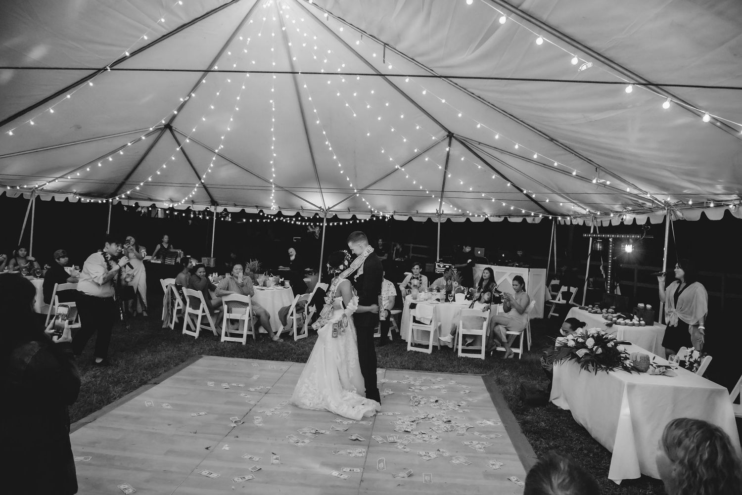 Black and white panoramic collage of an elegant outdoor wedding reception under a tent with string lights and dancing.