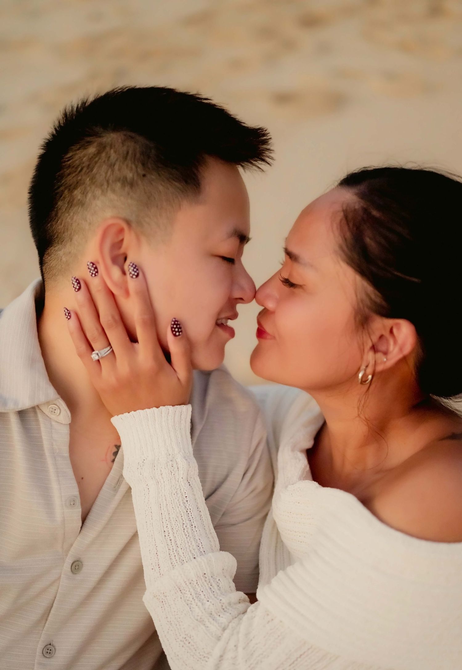 A couple in white sweaters share an intimate moment together in a series of romantic close-up photos.