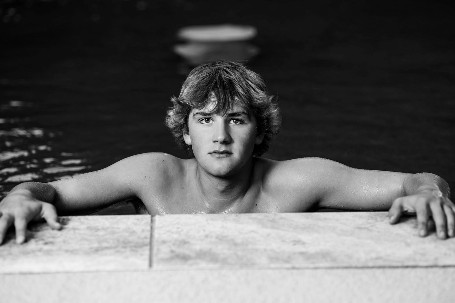 A black and white artistic photo series showing hands emerging from dark water against a stark background.