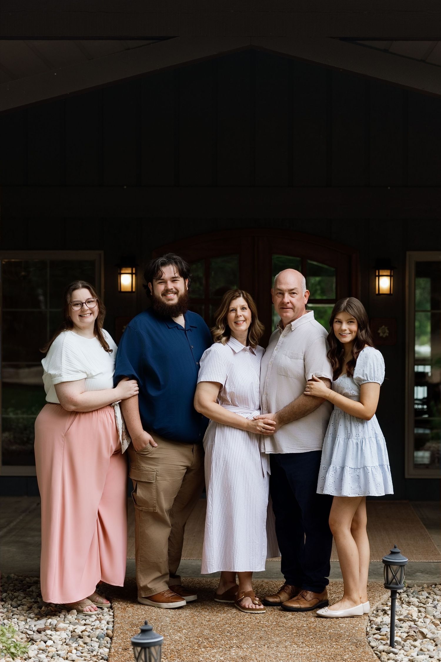Extended family posing together outside a rustic home during a Southern Illinois family photography session