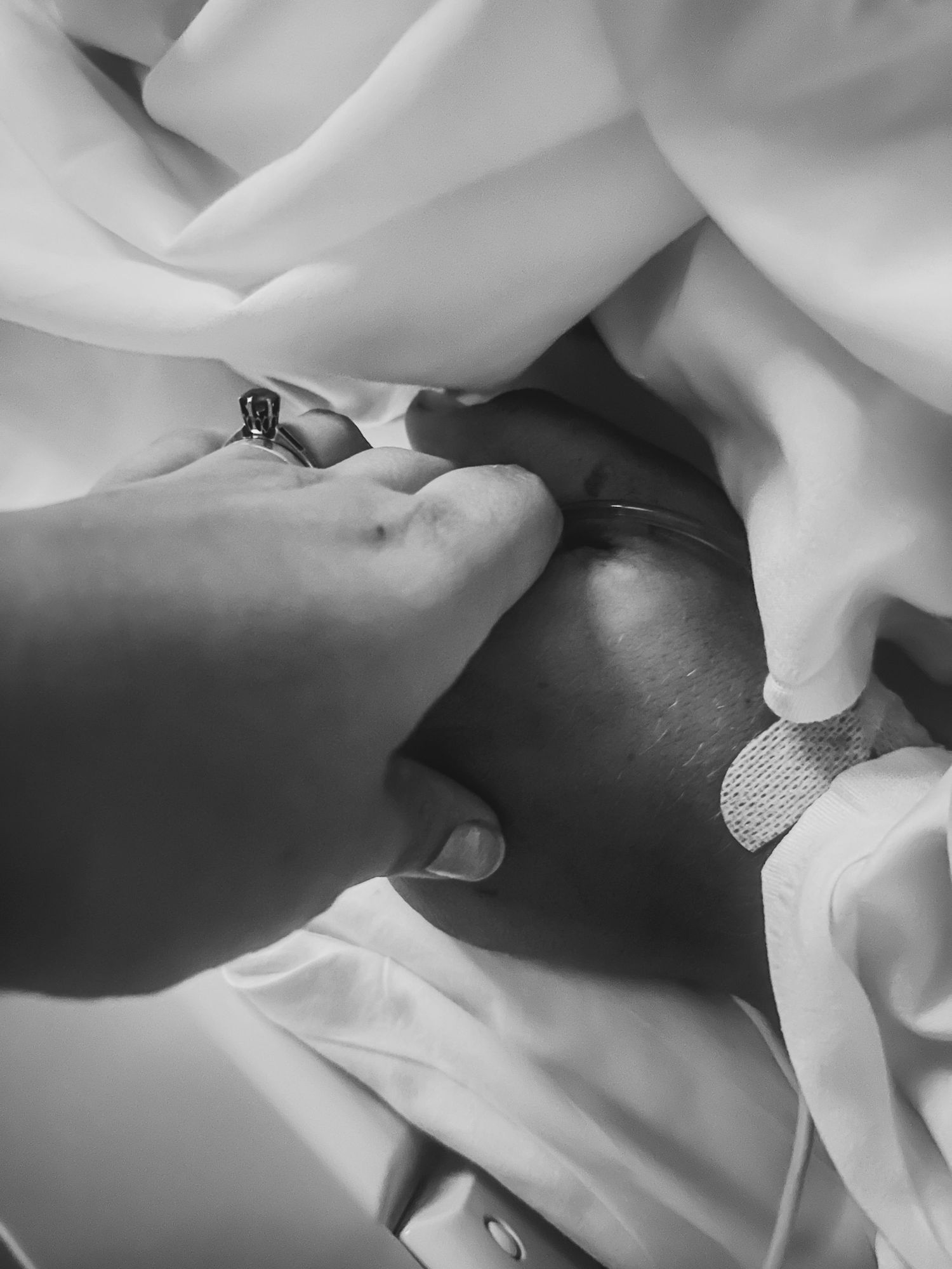 Medical professional hands working with medical equipment and white fabric.