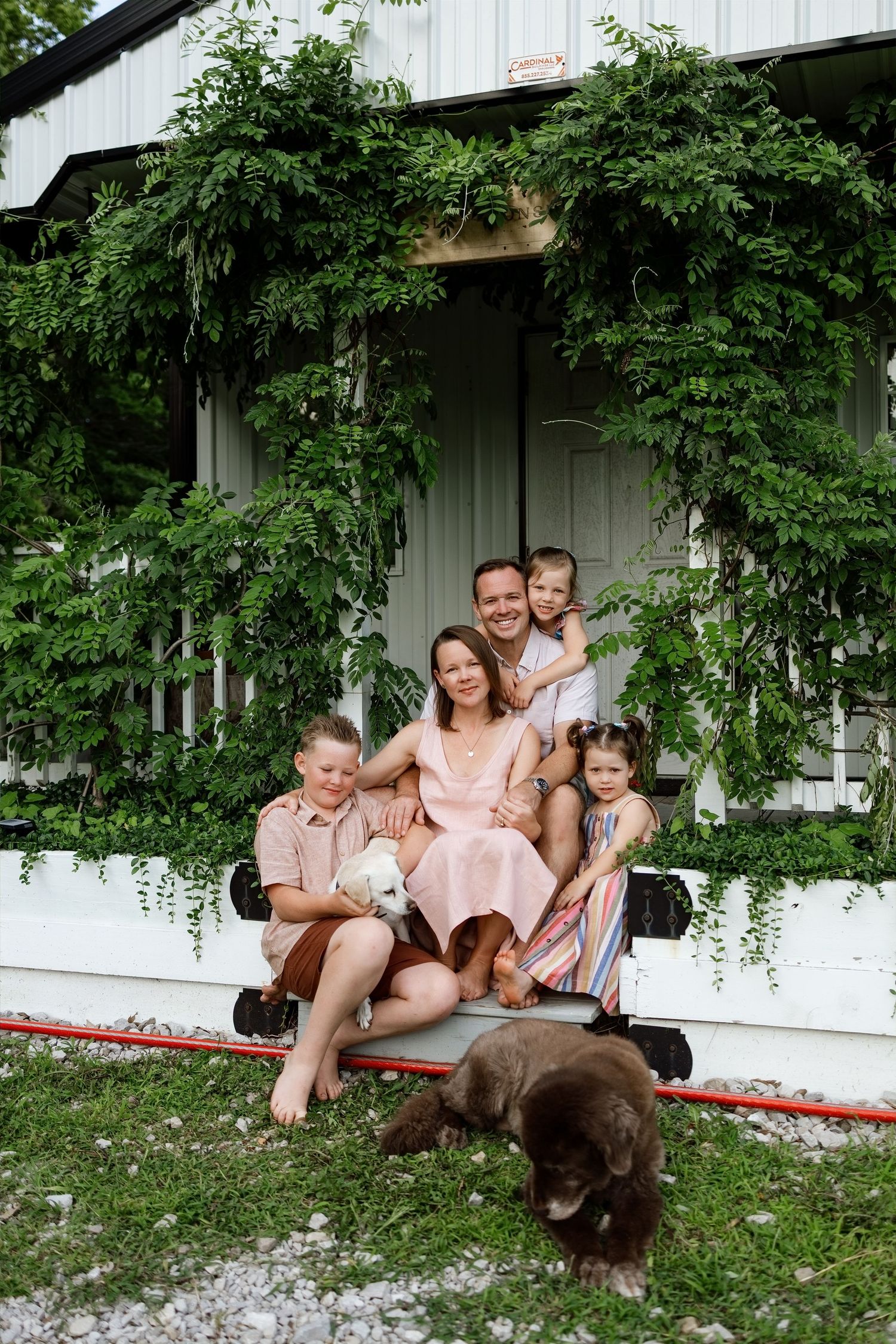 Family of four with their dog during an outdoor family photography session in the Edwardsville area