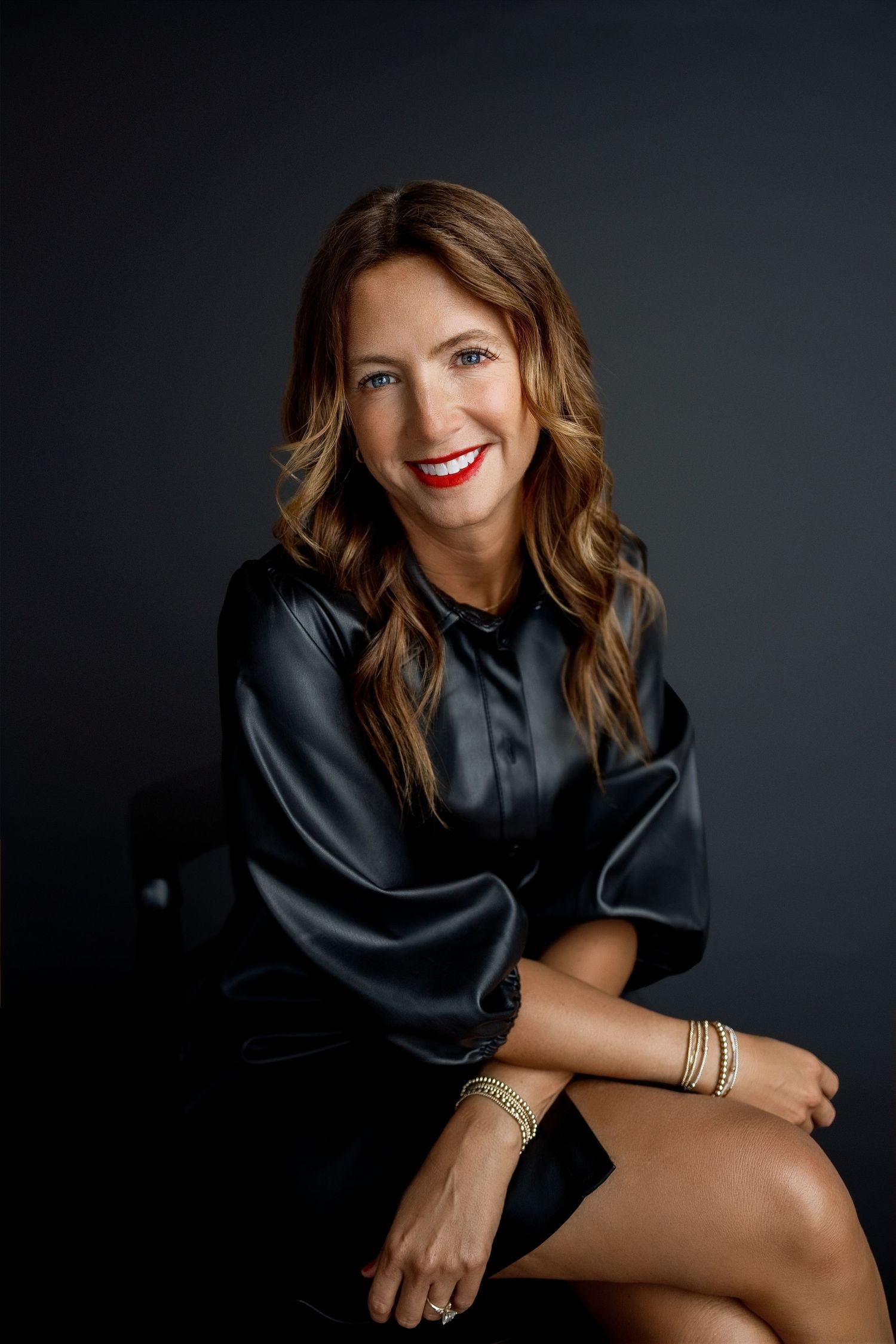 Female podcast host smiling confidently during an individual personal-brand portrait session in Edwardsville