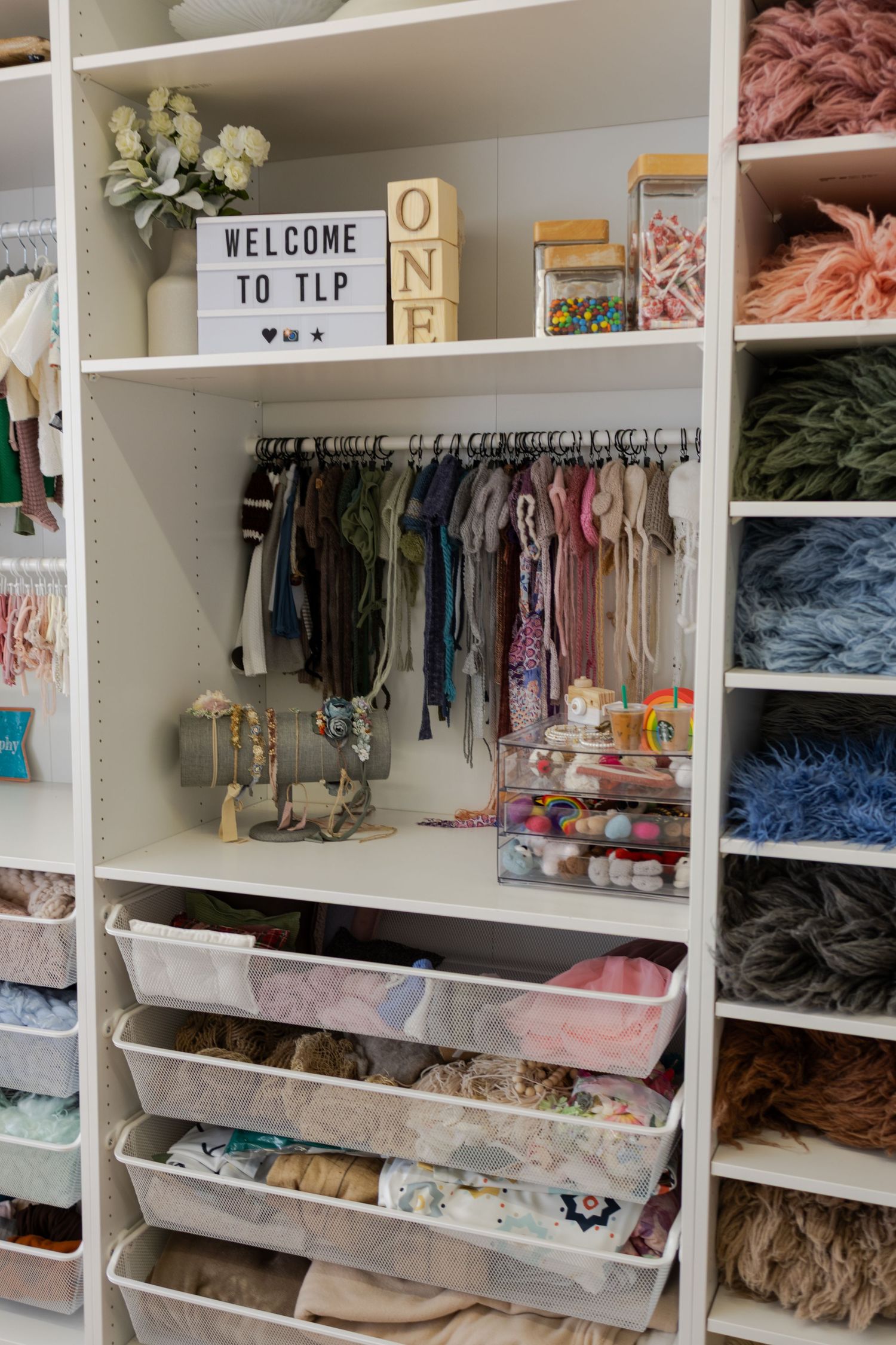 Organized collection of newborn wraps, ribbons, props, and styling supplies at Tara Lee Photography