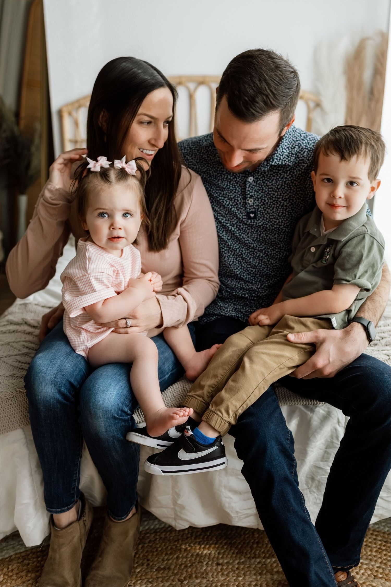 Parents sharing a playful moment with their son and daughter during an Edwardsville milestone photography session