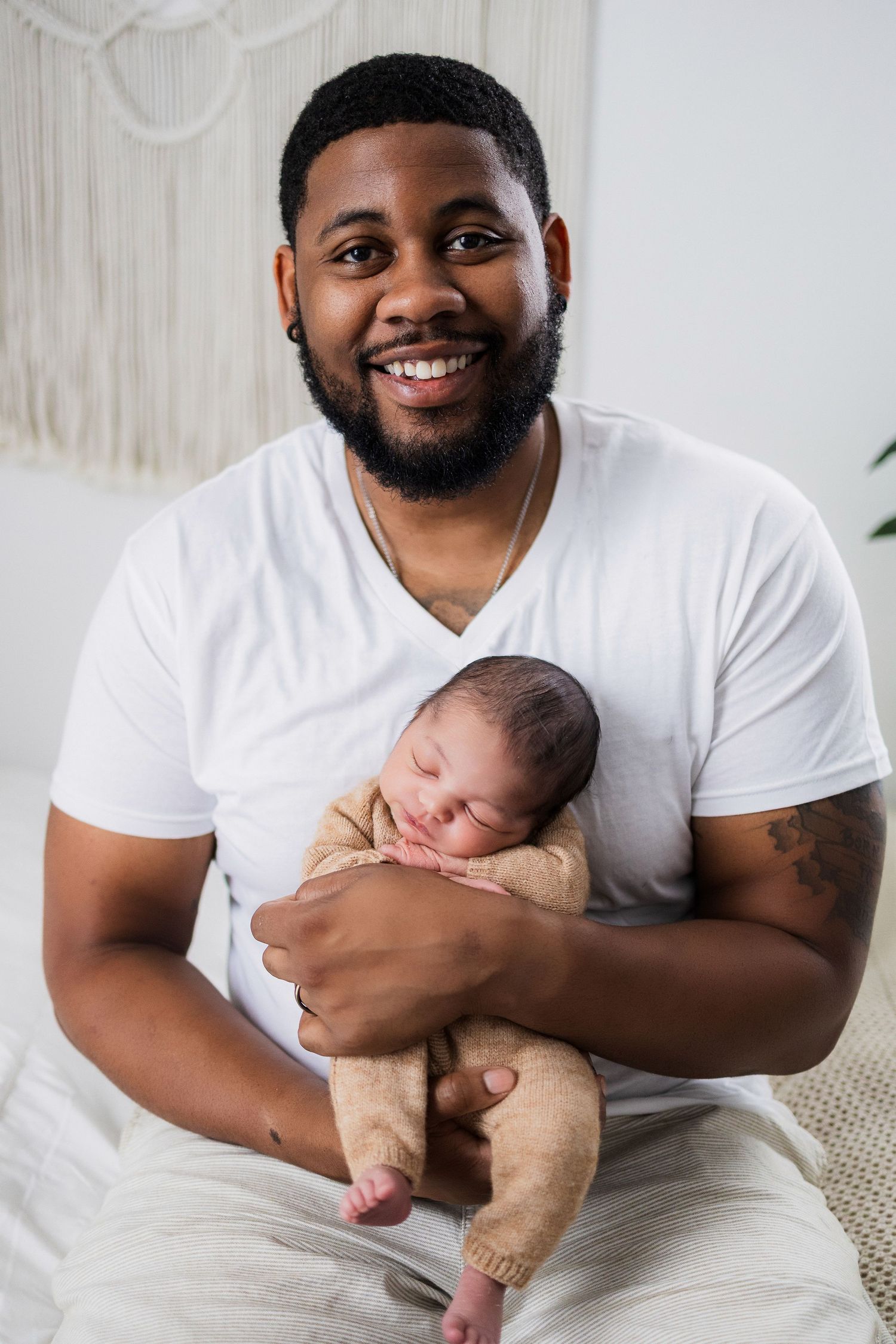 A sequence of joyful moments between a parent holding and bonding with their newborn baby.