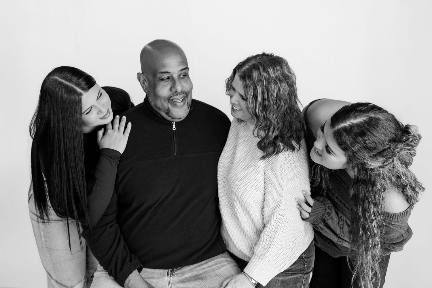 Black-and-white family portrait filled with laughter during a studio photography session at Tara Lee Photography