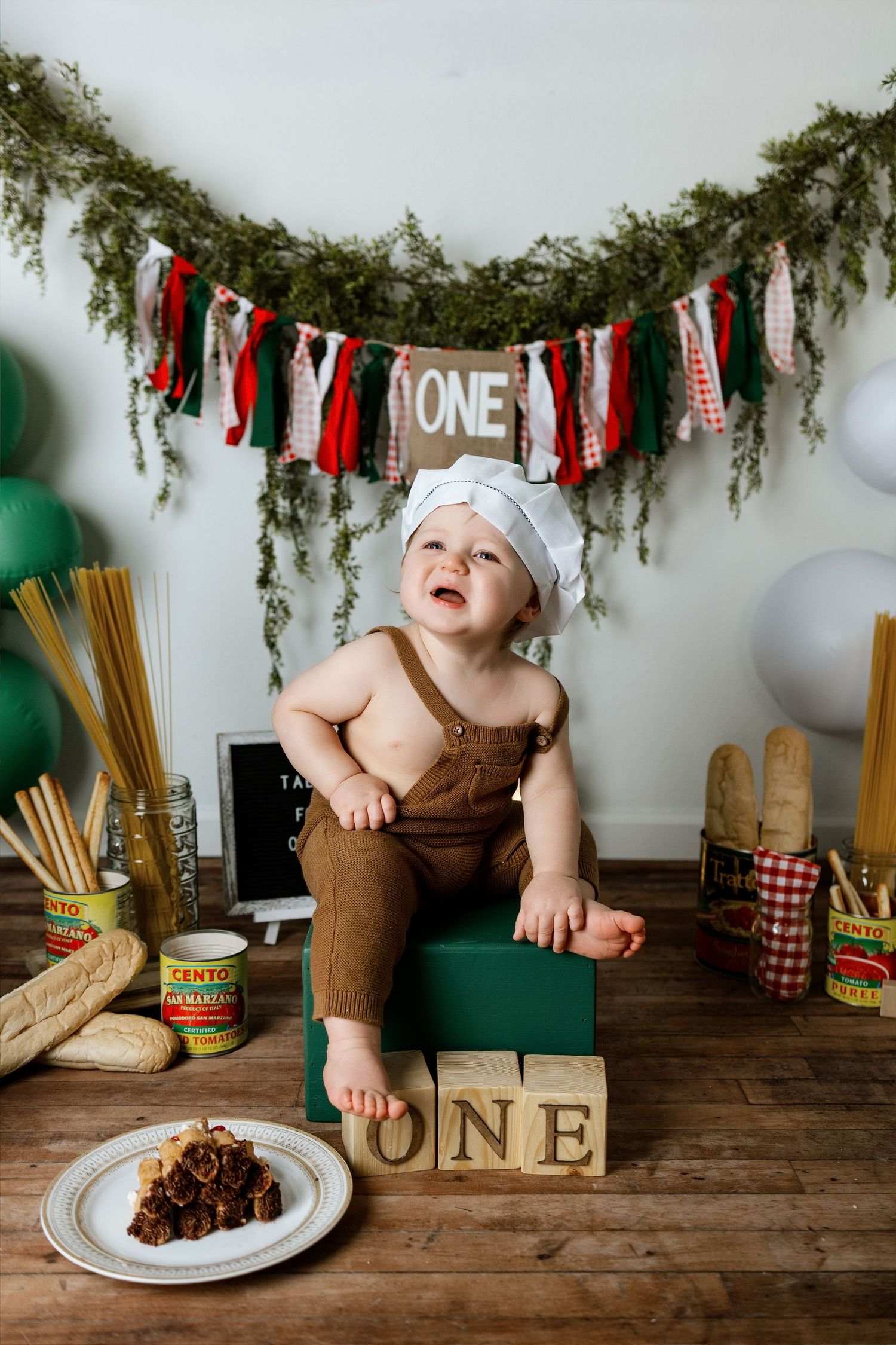 A first birthday cake smash photo session sequence showing decorative banners, a green chair, and chocolate cake on a plate.