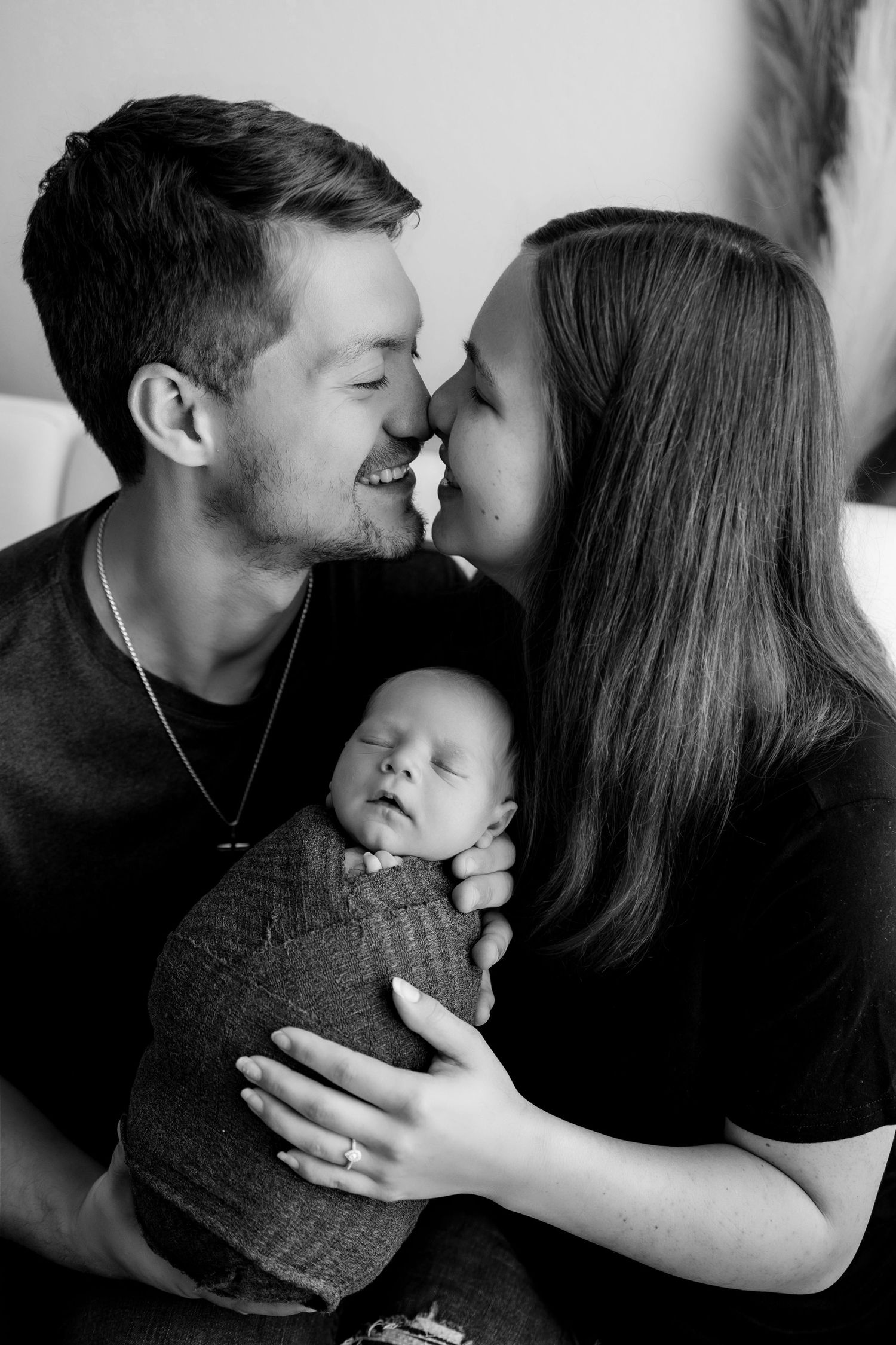 Black and white intimate family portrait series showing tender moments of affection and embrace.