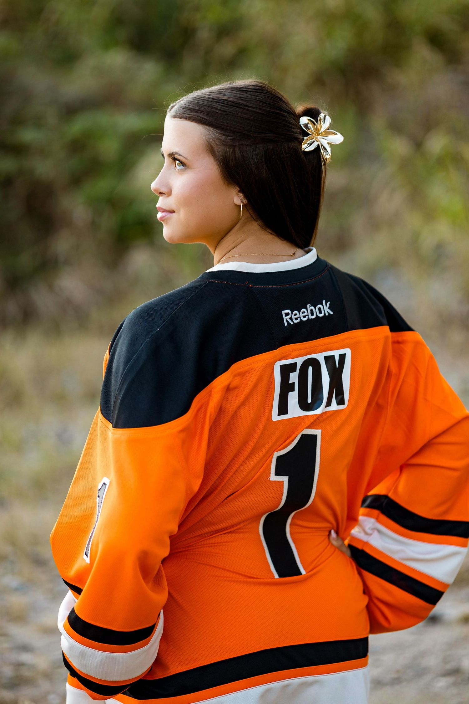 Athletic jersey in orange and black with number 1 and FOX text displayed from multiple angles.